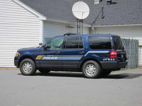 2001 Ford Crown Victoria - Side view of a blue police SUV with markings indicating it belongs to Kingston Police.