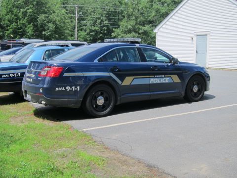 2001 Ford Crown Victoria - A dark blue police car with "KINGSTON POLICE" markings is parked next to another police vehicle.