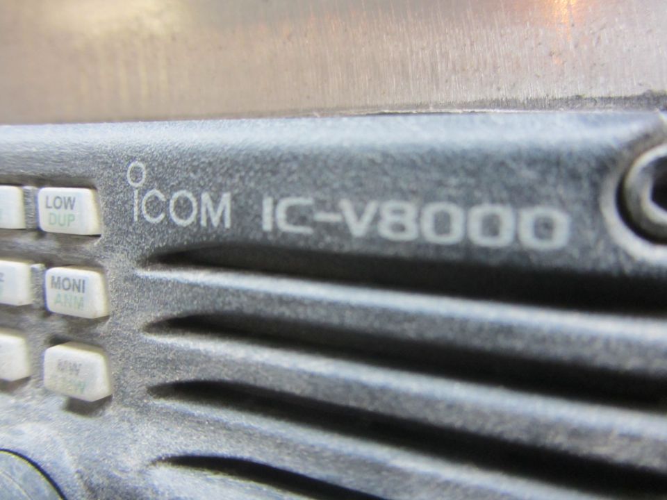 Close-up of an Icom IC-V8000 radio faceplate showing the model name and buttons