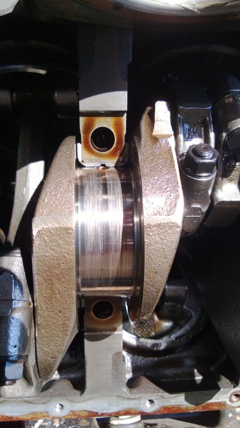 1994 Ford Bronco - Close-up view of an engine's crankshaft and connecting rod assembly.