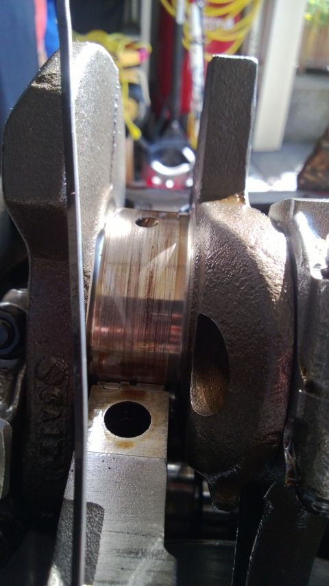 1994 Ford Bronco - Engine crankshaft bearing showing signs of wear and oil.