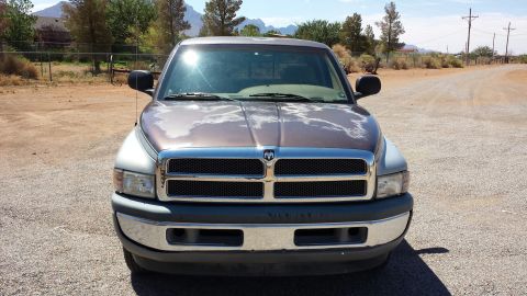 1995 Ford Bronco - This Dodge Ram pickup truck is shown from the front, revealing its grille and headlights, with noticeable paint deterioration on the hood.