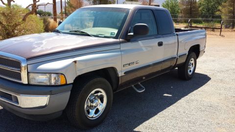 1995 Ford Bronco - This 1994 Dodge Ram 1500 pickup truck has a two-tone paint scheme and chrome wheels.