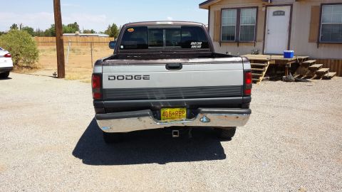 1995 Ford Bronco - This Dodge pickup truck is parked in front of a house with wooden stairs.