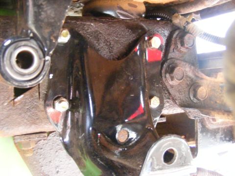 1996 Ford Bronco - This image shows a close-up view of a vehicle's suspension component, focusing on a metal bracket and its bolts.