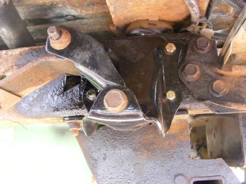1996 Ford Bronco - Close-up view of a vehicle's underbody suspension component, showing bolts and signs of rust.