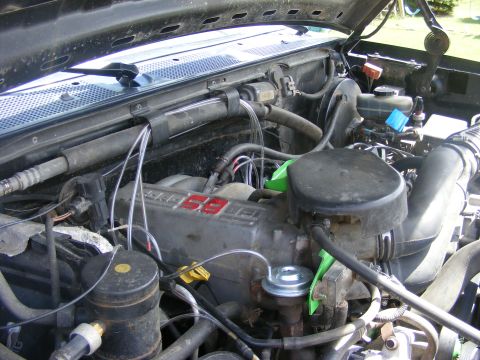 1996 Ford Bronco - Close-up of a Ford 5.8L V8 engine, likely from a 1996 model year vehicle.