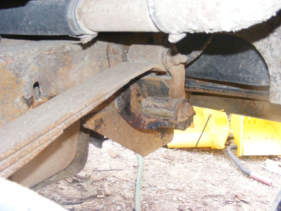 rusted leaf spring mount with visible corrosion and wear