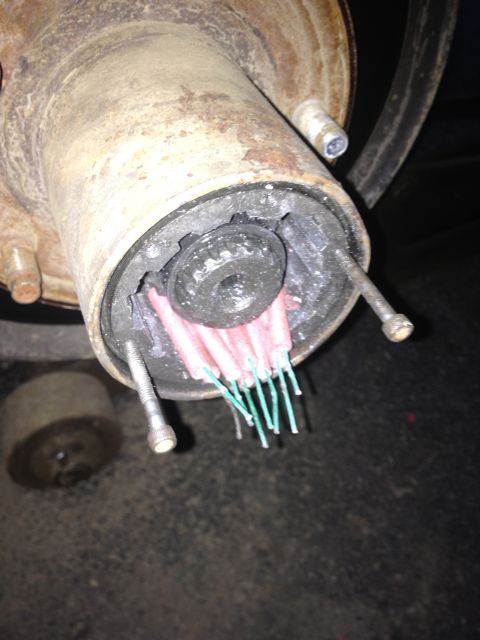 1979 Ford Bronco - Firecrackers are jammed into a vehicle's hub assembly, suggesting a destructive modification or prank.