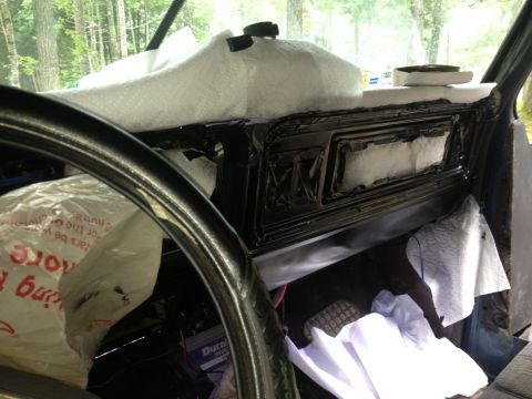 1979 Ford Bronco - The interior of a vehicle is shown with the dashboard area covered in insulation and protective wrap during a project.