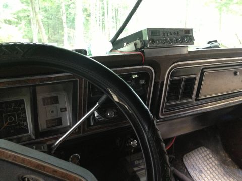 1979 Ford Bronco - Interior view of a 1979 Ford Bronco, a CB radio mounted on the dash and a worn steering wheel cover.