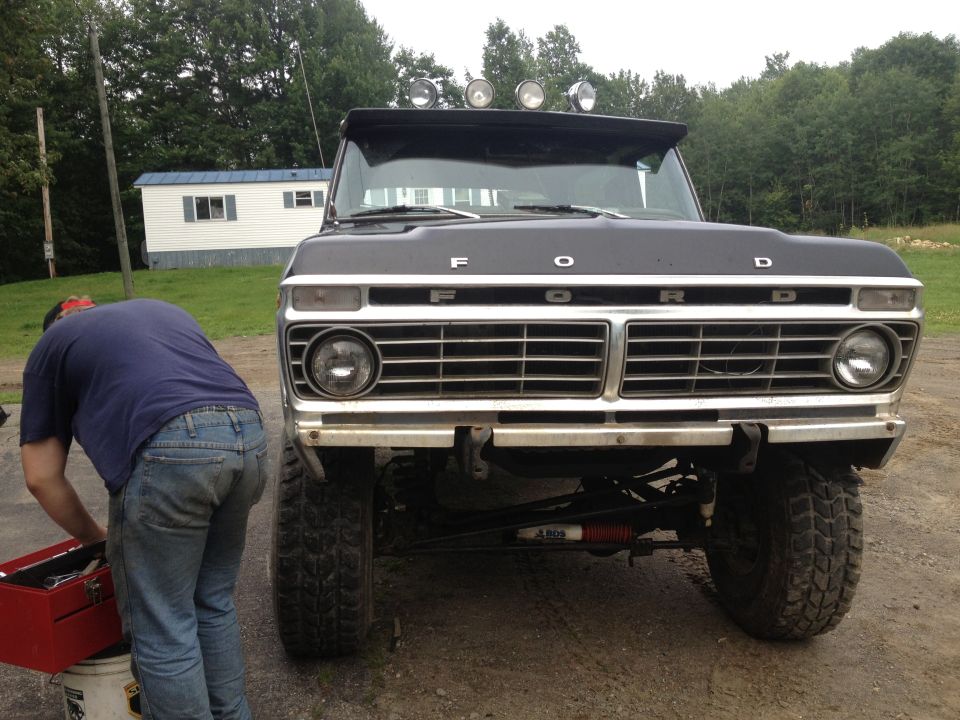 Black 1979 Ford Bronco front view with chrome grille and four auxiliary lights on the visor