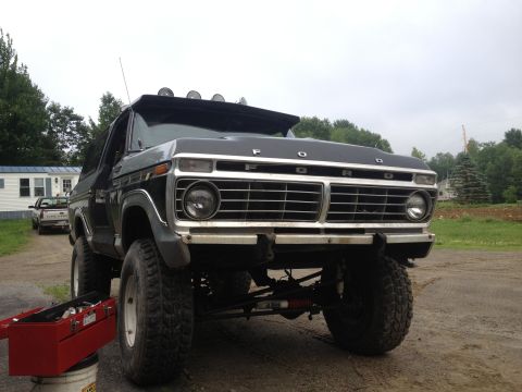 1979 Ford Bronco - This 1979 Ford Bronco is shown from the front, a prominent grille and aftermarket roof lights.