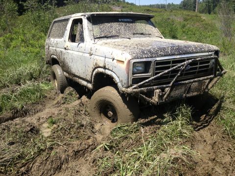 1979 Ford Bronco - This 1979 Ford Bronco is deeply stuck in mud, with its front end partially submerged.