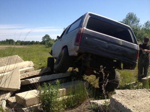 1979 Ford Bronco - Ford Bronco is shown navigating an obstacle course made of concrete blocks.
