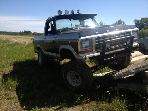 1979 Ford Bronco - This modified Ford Bronco is shown off-road, navigating over concrete obstacles.
