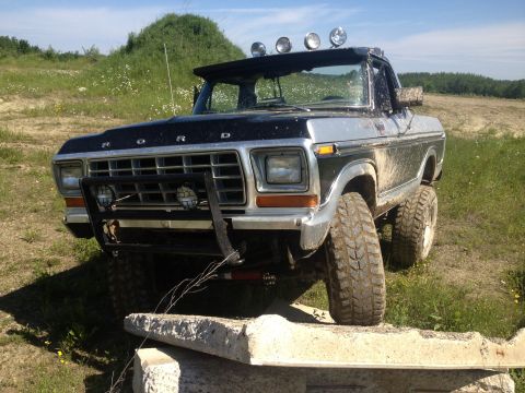 1979 Ford Bronco - This modified Ford Bronco is shown off-roading over concrete blocks.