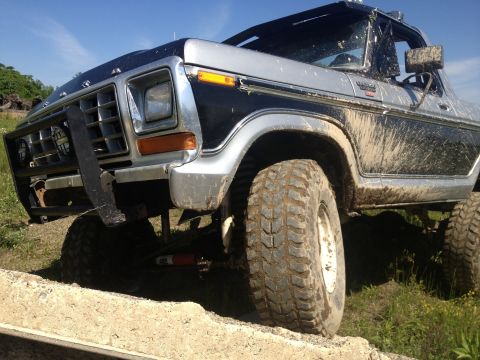 1979 Ford Bronco - This 1978 Ford Bronco is covered in mud and has been modified with a brush guard and off-road tires.