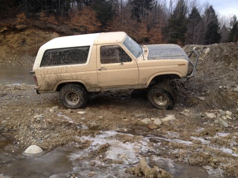1979 Ford Bronco - This 1979 Ford Bronco navigates a muddy, off-road terrain with a custom front bumper.