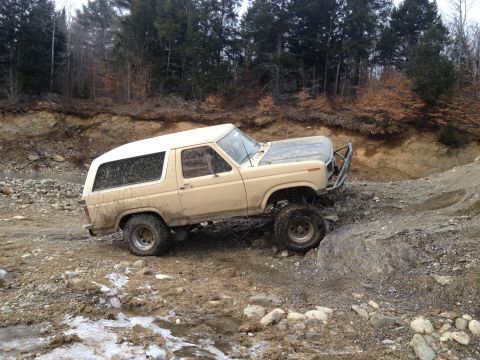 1979 Ford Bronco - This 1978 Ford Bronco is shown off-roading on a rocky, muddy trail.