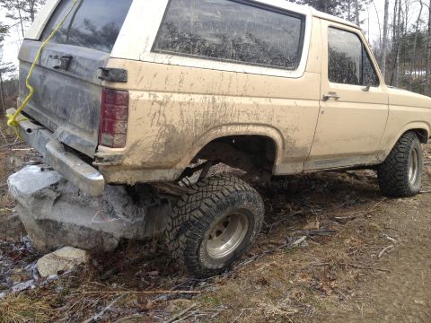 1979 Ford Bronco - This 1978 Ford Bronco is stuck on a rock, covered in mud.