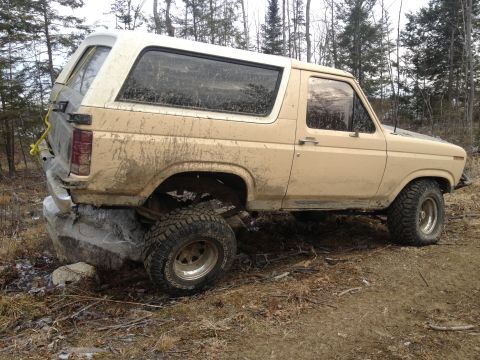 1979 Ford Bronco - This 1978 Ford Bronco is in a precarious position, high-centered on a large rock in a wooded area.