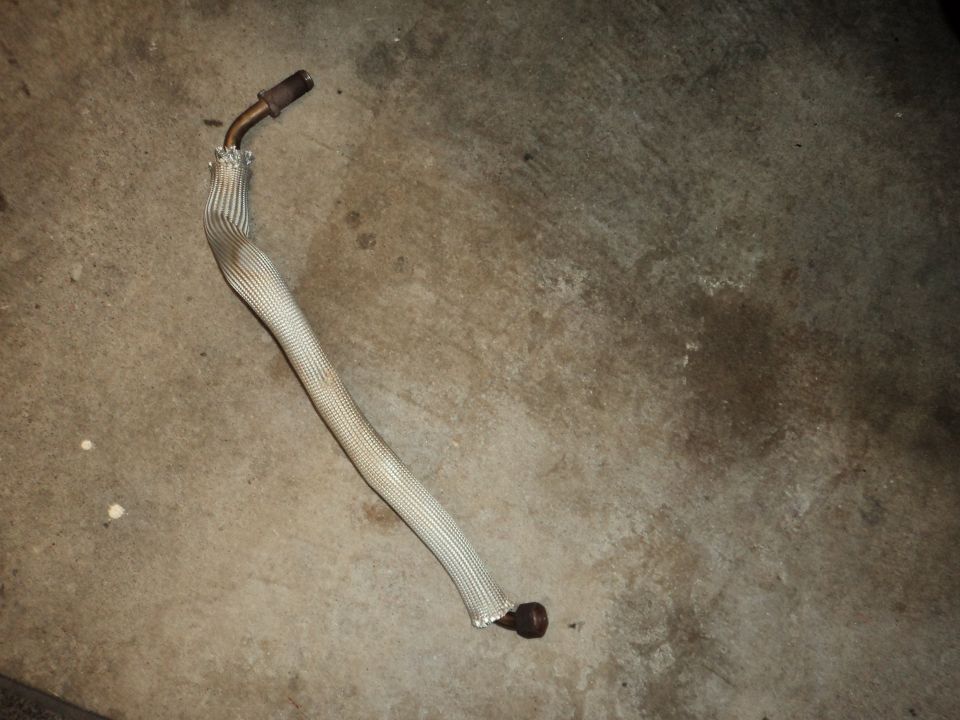 exhaust pipe with heat shield on concrete floor