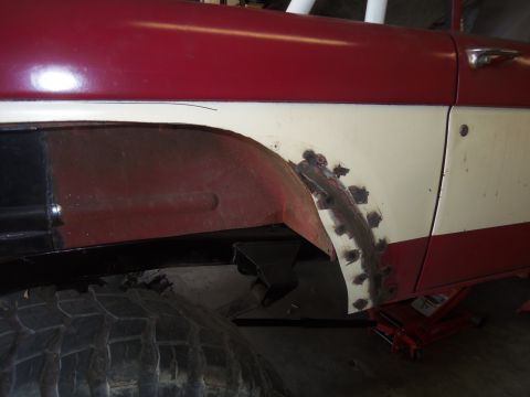 1968 Ford Bronco - The rear wheel well of a 1968 Ford Bronco shows signs of modification and repair.