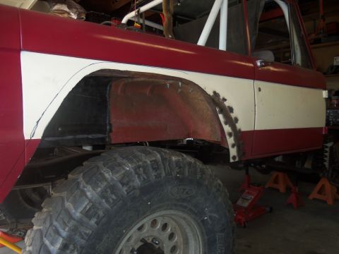 1968 Ford Bronco - This 1968 Ford Bronco is undergoing modifications to its rear wheel well, showing the extent of the custom work.