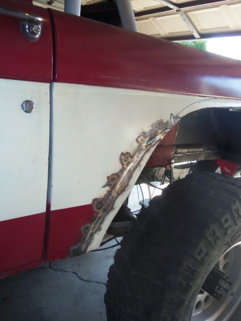 1968 Ford Bronco - This vehicle's rear wheel well is undergoing repair due to significant rust damage.
