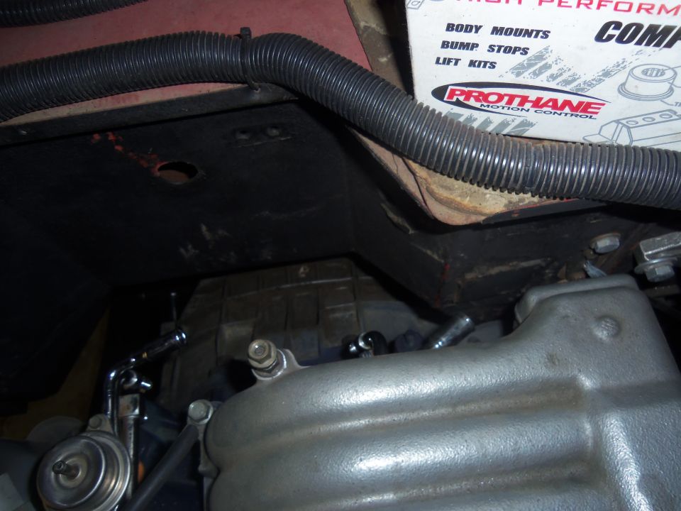 Engine intake manifold and fuel filter assembly with black corrugated tubing