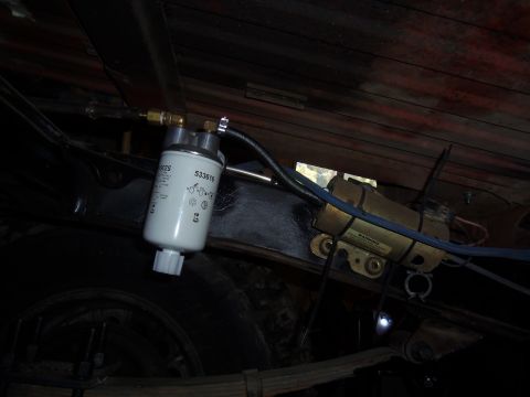 1968 Ford Bronco - Close-up of a fuel filter and pump assembly, likely under a vehicle.