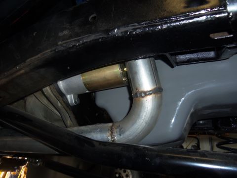 1968 Ford Bronco - Underside view of a vehicle's exhaust system and starter motor, with visible welding on the exhaust pipe.