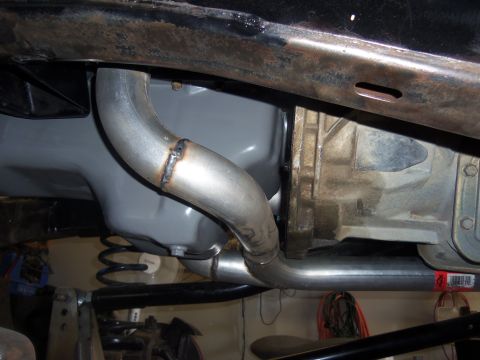 1968 Ford Bronco - Close-up view of a vehicle's exhaust system and transmission components.