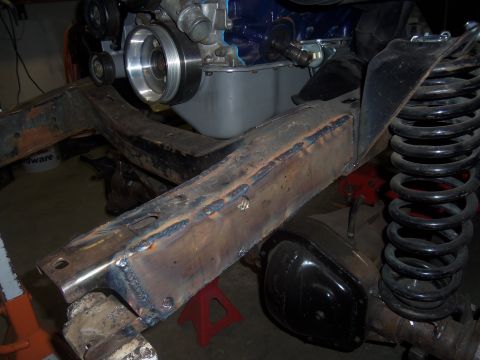 1968 Ford Bronco - Close-up view of vehicle frame modifications and engine components.