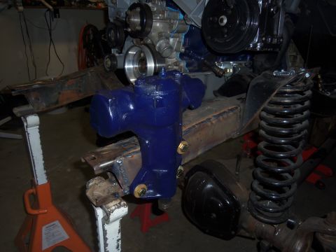 1968 Ford Bronco - Close-up of a vehicle's steering box and engine components, supported by jack stands.