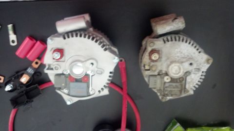 1995 Ford Bronco - Comparison of a new and used alternator, along with associated electrical components.