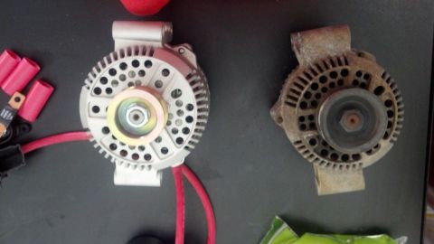 1995 Ford Bronco - A new alternator is shown next to an older, used one.