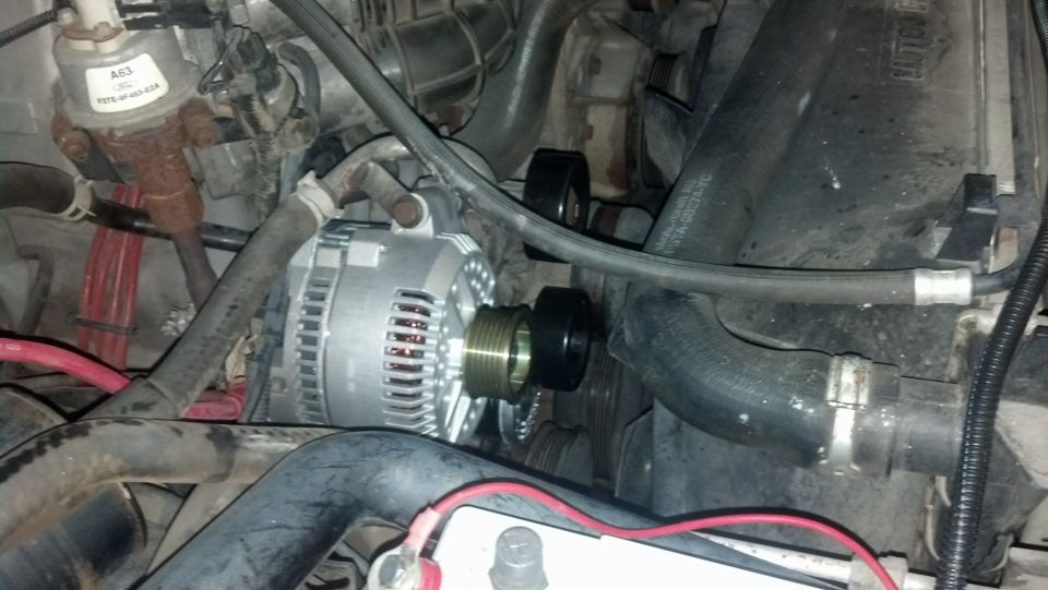 Close-up of an alternator and engine hoses, with a label reading 'A63' visible