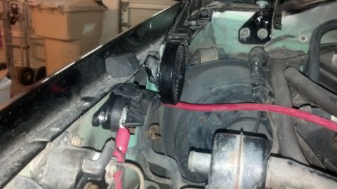 1995 Ford Bronco - A close-up view of electrical wiring and components within a vehicle's engine compartment.