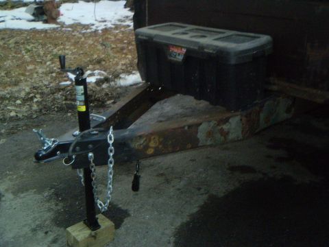 1979 Ford Bronco - A trailer hitch assembly and a toolbox are visible on a rusty trailer frame.