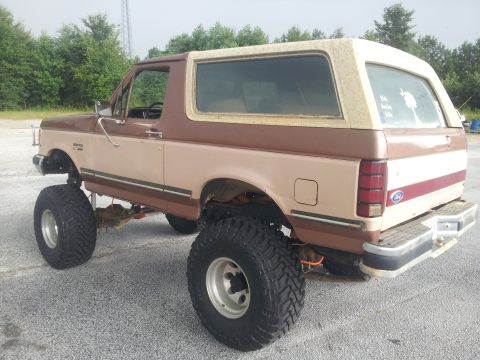 1988 Ford Bronco - This lifted Ford Bronco has a two-tone paint scheme and aggressive off-road tires.