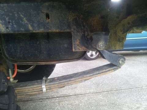 1988 Ford Bronco - Detail shot of a vehicle's suspension components, showing a leaf spring attached to the frame.