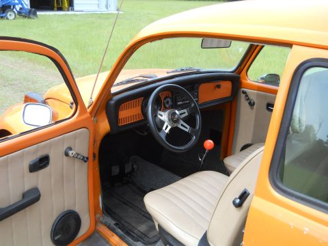 1992 Ford Bronco - Interior view of an orange Volkswagen Beetle, showing custom steering wheel and shifter.
