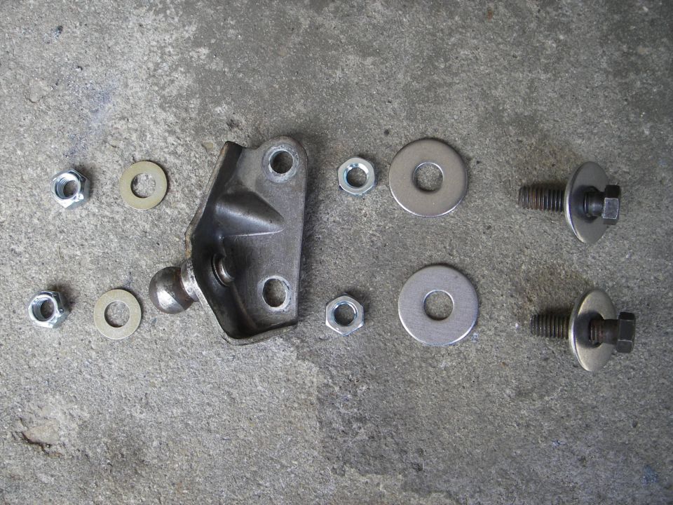 here's the stack of hardware; 7/16"-14 grade 8 bolts from the stash, a stainless fender washer on each side of the frame, a jam nut to keep the height down, the bracket, a hard washer and a self locking nut