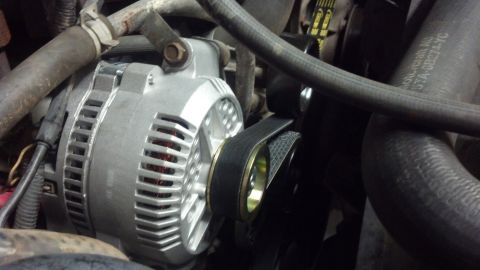 1995 Ford Bronco - Vehicle alternator with drive belt. Text on hose reads 'MORSECRAN AC 37A-GB274-YC'.