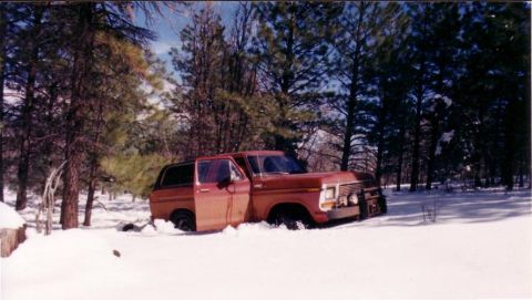 1979 Ford Bronco - This 1978 Ford Bronco is stuck in the snow with its door open.
