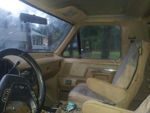 1988 Ford Bronco - Interior view of a 1988 Ford Bronco, tan upholstery and dashboard details.