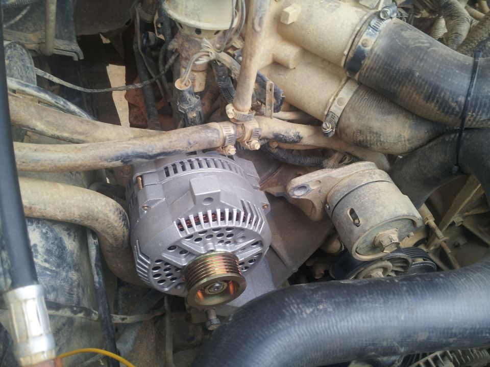 Alternator and engine hoses in a dirty engine bay
