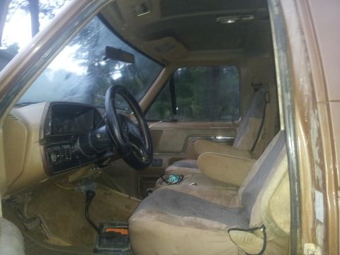 1988 Ford Bronco - Interior view of a 1988 Ford Bronco, showing the tan seats, dashboard, and steering wheel.